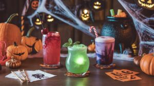 A festive Halloween mocktail bar featuring colorful non-alcoholic drinks and spooky decorations for a haunting good time.