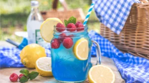 Blue Raspberry Lemonade Mocktail in mason jar with fresh fruit garnish