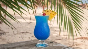 Tropical Blue Splash mocktail with pineapple garnish in a hurricane glass