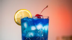 Blue Lagoon Mocktail in a tall glass garnished with lemon slice and cherry