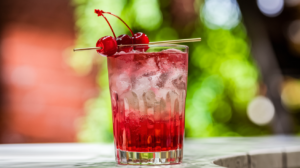 Classic Shirley Temple mocktail with maraschino cherry garnish showing signature red gradient