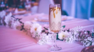 A sophisticated elderflower mocktail with a golden honey accent, served in a crystal champagne flute with a light, ethereal appearance for a great wedding mocktail