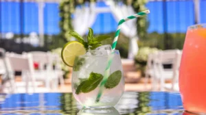 A crisp mint lime spritzer with muddled mint leaves, creating a refreshing green-tinted wedding mocktail